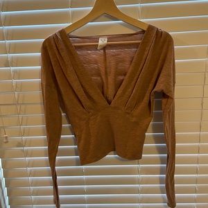 Long sleeve, rust orange, deep V top.